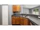 Efficient kitchen with wood cabinets, double sink, and dishwasher at 49 Fisher Way, Ocklawaha, FL 32179