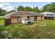 Backyard of the home with a large grassy area at 49 Fisher Way, Ocklawaha, FL 32179