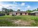 House backyard with green grass and wooden fence at 49 Fisher Way, Ocklawaha, FL 32179