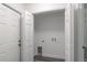 Bright laundry room with built-in shelving and vinyl flooring at 1 Pine Trace Trl, Ocala, FL 34472