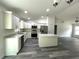 Modern kitchen with island, stainless steel appliances, and white cabinetry at 1 Pine Trace Trl, Ocala, FL 34472