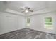 Bright bedroom with double door closet and gray vinyl flooring at 1 Pine Trace Trl, Ocala, FL 34472