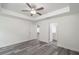 Spacious bedroom with ceiling fan, gray vinyl flooring, and access to bathroom at 1 Pine Trace Trl, Ocala, FL 34472