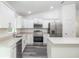 Modern kitchen with white cabinets and stainless steel appliances at 1 Pine Trace Trl, Ocala, FL 34472