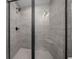 Large walk in shower with gray tile and glass enclosure at 14914 Se 28Th Ct, Summerfield, FL 34491