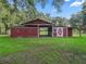 Red barn with stalls and covered area, ideal for animals at 11831 Sw Highway 484, Dunnellon, FL 34432