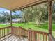 Elevated deck overlooking the backyard, pool, and surrounding landscape at 11831 Sw Highway 484, Dunnellon, FL 34432