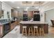 Spacious kitchen with dark wood cabinets, granite countertops, and an island with seating at 11831 Sw Highway 484, Dunnellon, FL 34432