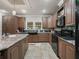 Spacious kitchen with ample cabinetry, granite countertops, and modern appliances at 11831 Sw Highway 484, Dunnellon, FL 34432