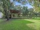 Covered structure in the backyard providing shade and a small fenced area at 11831 Sw Highway 484, Dunnellon, FL 34432