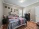 Bright bedroom with a full-size bed and wood floors at 11831 Sw Highway 484, Dunnellon, FL 34432