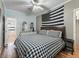 King-size bedroom with wood floors and en-suite bathroom at 11831 Sw Highway 484, Dunnellon, FL 34432