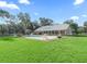 Large backyard with a sparkling pool and lush green grass at 11831 Sw Highway 484, Dunnellon, FL 34432