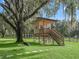 Charming treehouse with stairs, a tire swing, and a grassy area at 11831 Sw Highway 484, Dunnellon, FL 34432
