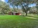Rustic red barn situated in a verdant pasture at 11831 Sw Highway 484, Dunnellon, FL 34432