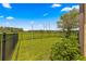 Open backyard view, showcasing a large grassy area and a black fence at 9793 Sw 63Rd Loop, Ocala, FL 34481