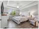 Spacious main bedroom with king bed, wood-look floors, and plenty of light at 9793 Sw 63Rd Loop, Ocala, FL 34481