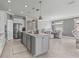 Open kitchen with large island, stainless steel appliances, and view to Gathering room at 9793 Sw 63Rd Loop, Ocala, FL 34481