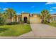 House exterior with a tan stucco finish and palm trees at 9793 Sw 63Rd Loop, Ocala, FL 34481