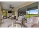 Covered lanai with wicker furniture and view of the backyard and kitchen at 9793 Sw 63Rd Loop, Ocala, FL 34481