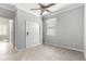 Small bedroom with tile floors, ceiling fan, and white closet doors at 9793 Sw 63Rd Loop, Ocala, FL 34481