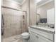 Modern bathroom with a walk-in shower, granite countertop, and white cabinets at 9793 Sw 63Rd Loop, Ocala, FL 34481