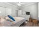 Spacious bedroom featuring a queen bed, dresser, and ceiling fan at 9793 Sw 63Rd Loop, Ocala, FL 34481