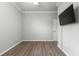 Spacious bedroom with wood-look floors and a large TV at 9793 Sw 63Rd Loop, Ocala, FL 34481