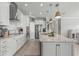 Modern kitchen with white cabinets, granite island, and stainless steel appliances at 9793 Sw 63Rd Loop, Ocala, FL 34481