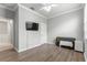 Bedroom with wood-look floors, mounted TV, and ceiling fan at 9793 Sw 63Rd Loop, Ocala, FL 34481
