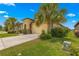 House exterior with a tan stucco finish and palm trees at 9793 Sw 63Rd Loop, Ocala, FL 34481