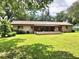 Backyard view of house with covered patio at 1779 Ne 12Th St, Ocala, FL 34470