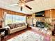Living room with stone fireplace and wood paneling at 1779 Ne 12Th St, Ocala, FL 34470