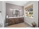 Spa-like bathroom with double vanity, gray tile, and a walk-in shower at 7137 & 7141 S Magnolia Ave, Ocala, FL 34476
