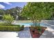 Inviting swimming pool with brick coping and lush landscaping at 7137 & 7141 S Magnolia Ave, Ocala, FL 34476