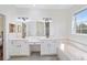 Elegant bathroom with double vanity, soaking tub, and large mirror at 7137 & 7141 S Magnolia Ave, Ocala, FL 34476