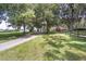 Long driveway leading to a barn and home nestled amongst lush trees at 7137 & 7141 S Magnolia Ave, Ocala, FL 34476