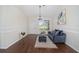 Living room with blue sofa and ottoman, hardwood floors at 7137 & 7141 S Magnolia Ave, Ocala, FL 34476