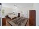 Bright main bedroom featuring a large bed and ensuite bathroom access at 7137 & 7141 S Magnolia Ave, Ocala, FL 34476
