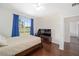 Bright bedroom with wood floors, large window, and view of the pasture at 7137 & 7141 S Magnolia Ave, Ocala, FL 34476