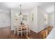 Charming dining area with a wooden table and chairs, hardwood floors, and natural light at 7137 & 7141 S Magnolia Ave, Ocala, FL 34476