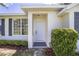 Front entrance with white door and landscaping at 7137 & 7141 S Magnolia Ave, Ocala, FL 34476