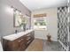 Elegant bathroom with double vanity, a large mirror, and a walk-in shower at 7137 & 7141 S Magnolia Ave, Ocala, FL 34476