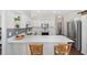 Modern kitchen with white cabinets, stainless steel appliances, and a breakfast bar at 7137 & 7141 S Magnolia Ave, Ocala, FL 34476