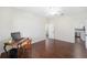 Home office with hardwood floors, desk, chair, and view into kitchen at 7137 & 7141 S Magnolia Ave, Ocala, FL 34476