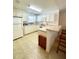 Bright kitchen with white cabinets, and a breakfast bar at 892 Nash Loop, The Villages, FL 32162