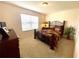 Bedroom with a dark-wood bed frame and a dresser at 892 Nash Loop, The Villages, FL 32162