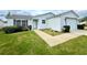 Single-story home with white siding, landscaping and a two-car garage at 892 Nash Loop, The Villages, FL 32162