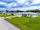 Single-story home with a spacious lawn and driveway at 1436 Ne 161St Pl, Citra, FL 32113