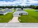 Single-story house with a large backyard, driveway, and spacious lot at 1436 Ne 161St Pl, Citra, FL 32113